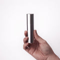Überlube Good-to-Go silver travel case held in one hand