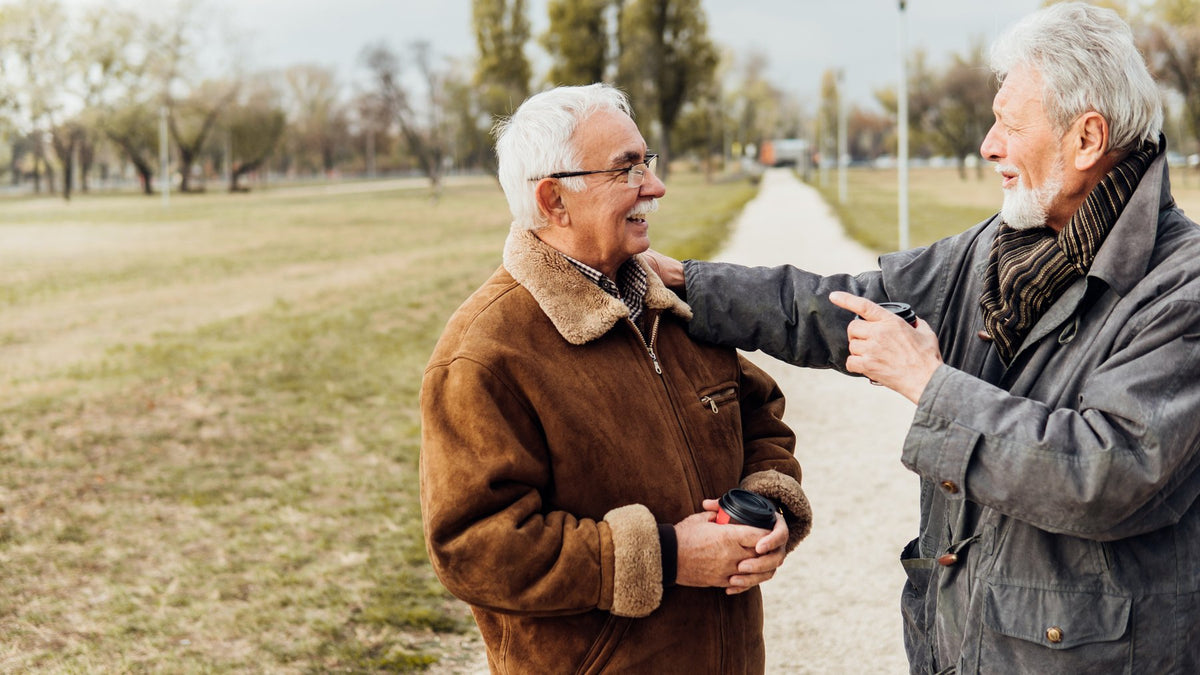 Two older men talking in a park